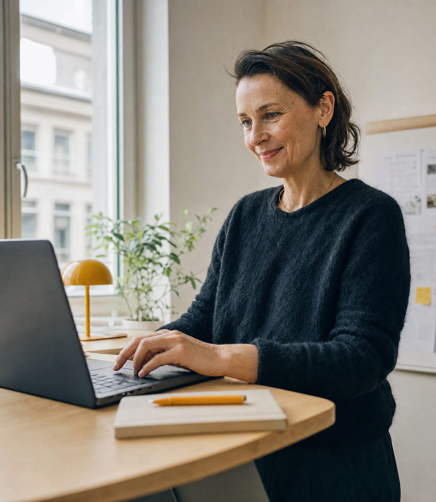 Founder approving delivered work on a laptop